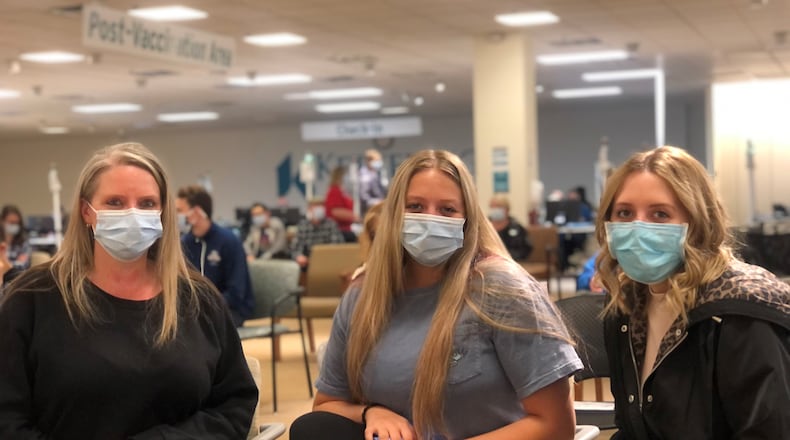 Missy Kozee and her daughters Jordyn, 17, and Alyssa, 22. Kozee was vaccinated a few weeks ago. Alyssa, a medical student, was vaccinated in February. Jordyn received her first shot at a Kettering Health Network clinic on Friday. CORNELIUS FROLIK / STAFF
