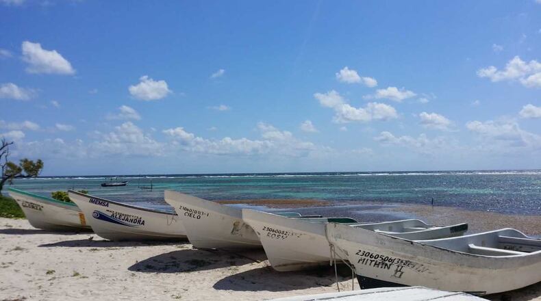 The Caribbean provides a lovely backdrop for beached boats. (Dawn Cate/Tampa Bay Times/TNS)