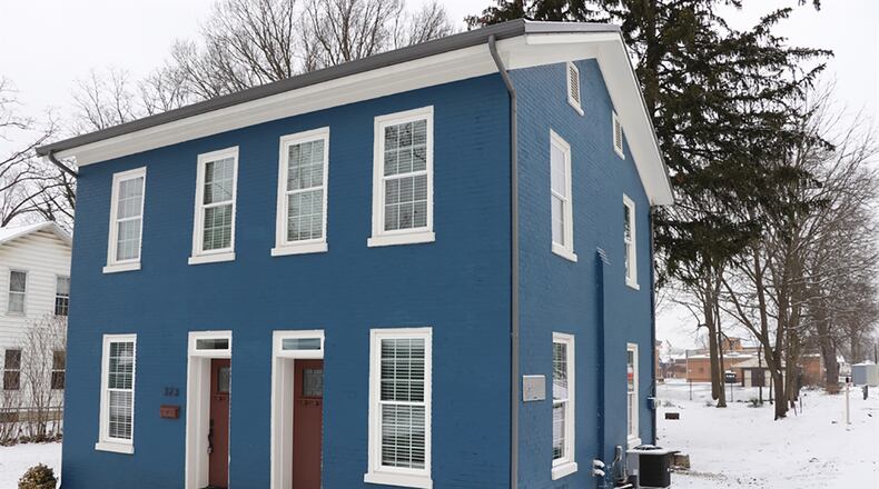 With about 1,470 sq. ft. of living space on a full basement, the brick, 3-bedroom home has been completely renovated. Concrete walkways lead to the concrete entry pad where a stone threshold accents the updated Shaker doors with transoms. Two single doors open into the main social area of the house. CONTRIBUTED PHOTO BY KATHY TYLER