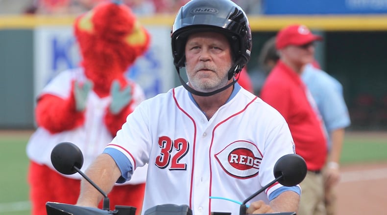 Former Reds pitcher Tom Browning rides a scooter past the dugout during a ceremony honoring Scooter Gennett before a game against the Dodgers on Friday, June 16, 2017, at Great American Ball Park in Cincinnati. David Jablonski/Staff