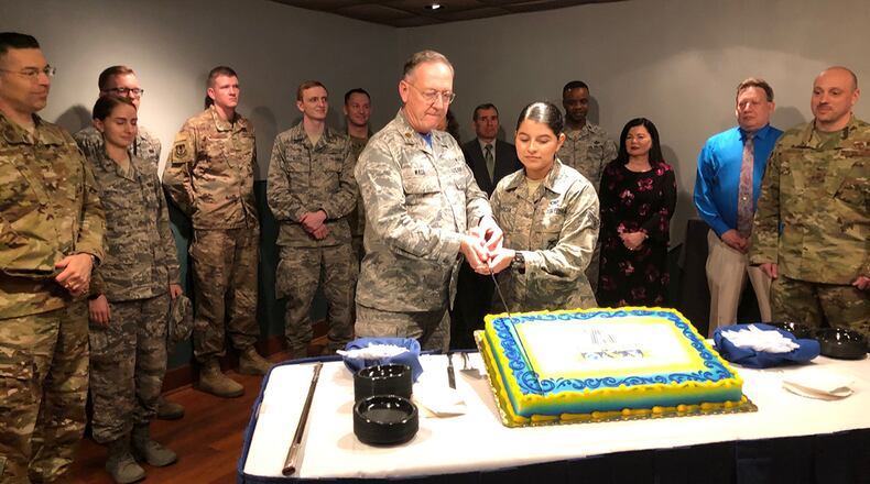 Maj. Anthony Wade, 88th Air Base Wing deputy chaplain, and Airman 1st Class Ashley Garcia, 88th Security Forces installation entry controller, cut a cake in celebration of the 75th anniversary of the 88th Air Base Wing April 5 in the Wright-Patterson Club. As part of the ceremony’s tradition, Wade and Garcia represented the oldest and youngest Airmen in the 88th Air Base Wing. (U.S. Air Force photo/Marie Vanover)