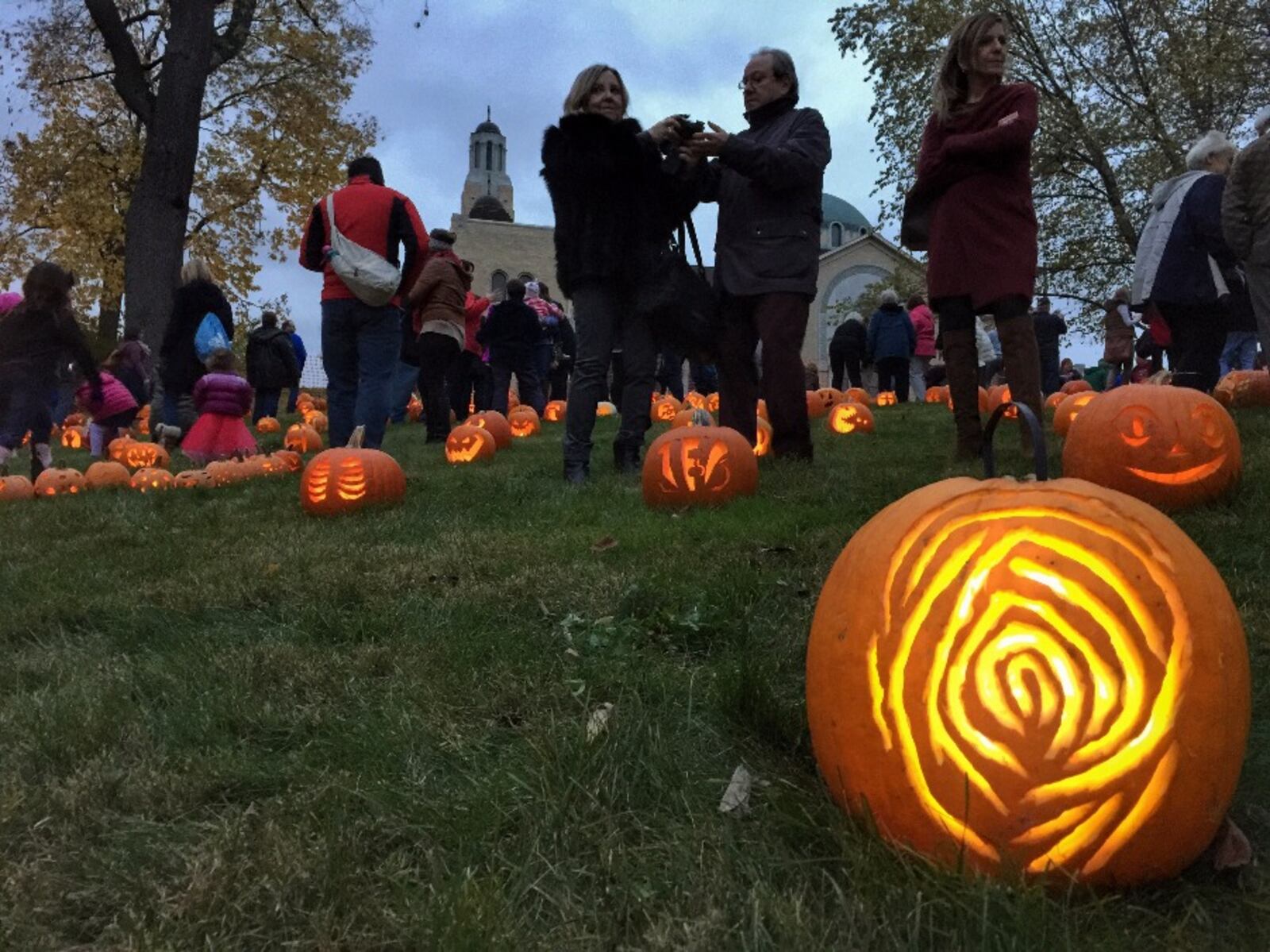 Cutline: Approximately 800 uniquely carved jack'o-lanterns on the hill behind the Greek Orthodox Church in the historic Grafton Hill neighborhood attracted hundreds of visitors Friday, Oct. 30. The Pumpkin Glow continues on Saturday evening, Oct. 31.