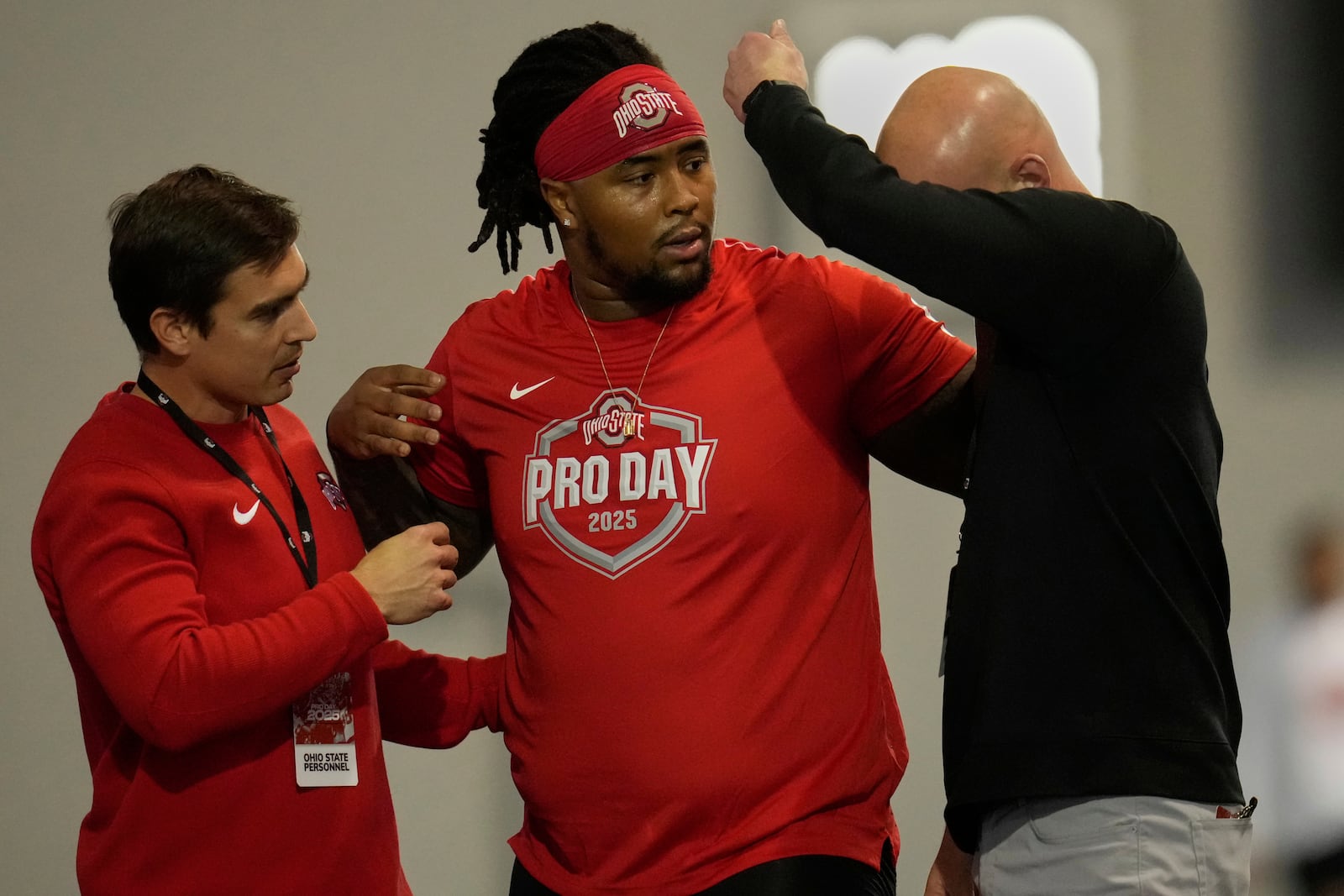 Ohio State's Tyleik Williams, center, is helped off the field after falling while running the 40-yard dash during the school's NFL football pro day, Wednesday, March 26, 2025, in Columbus, Ohio. (AP Photo/Sue Ogrocki)