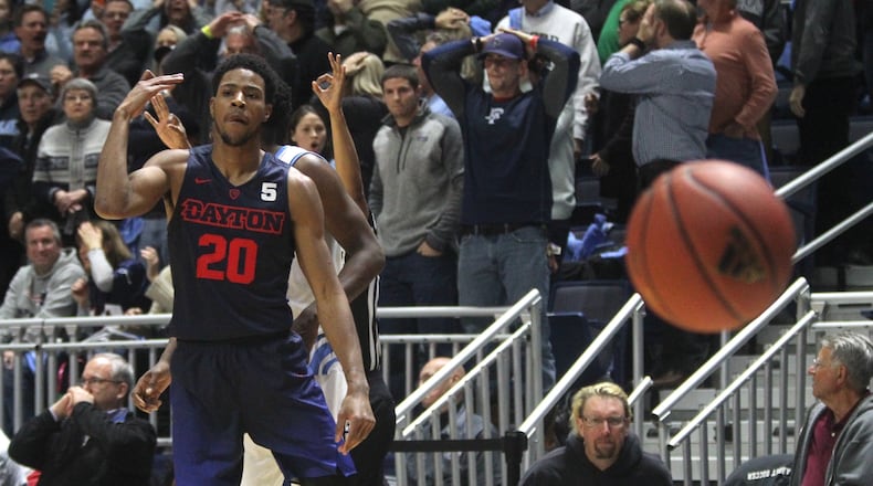 Dayton’s Xeyrius Williams celebrates his go-ahead 3 with 10 seconds left. David Jablonski/Staff