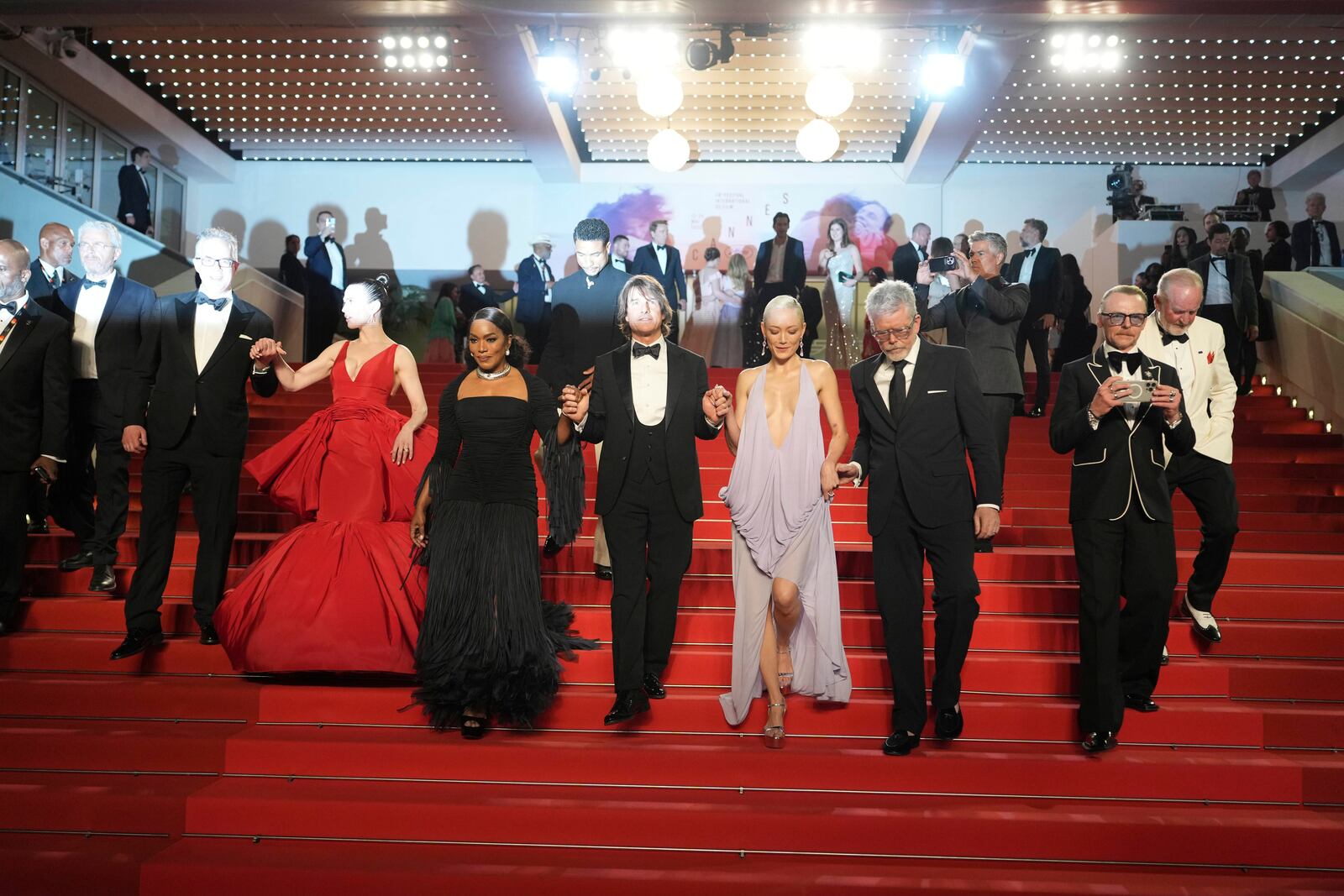 Editor Eddie Hamilton, from left, Hayley Atwell, Angela Bassett, Tom Cruise, Pom Klementieff, director Christopher McQuarrie, Simon Pegg and writer Erik Jendresen pose for photographers upon departure from the premiere of the film 'Mission: Impossible – The Final Reckoning' at the 78th international film festival, Cannes, southern France, Wednesday, May 14, 2025. (AP Photo/Natacha Pisarenko)