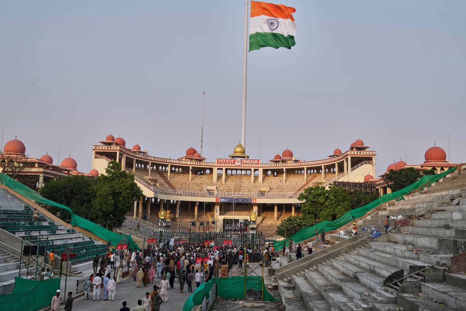 People gather near the closed gates for selfie after a daily closing ceremony by Pakistan's Rangers and Indian Border Security Forces soldiers, at the Wagah, a joint post on the Pakistan and India border, near Lahore, Pakistan, Saturday, May 3, 2025. (AP Photo/K.M. Chaudary)