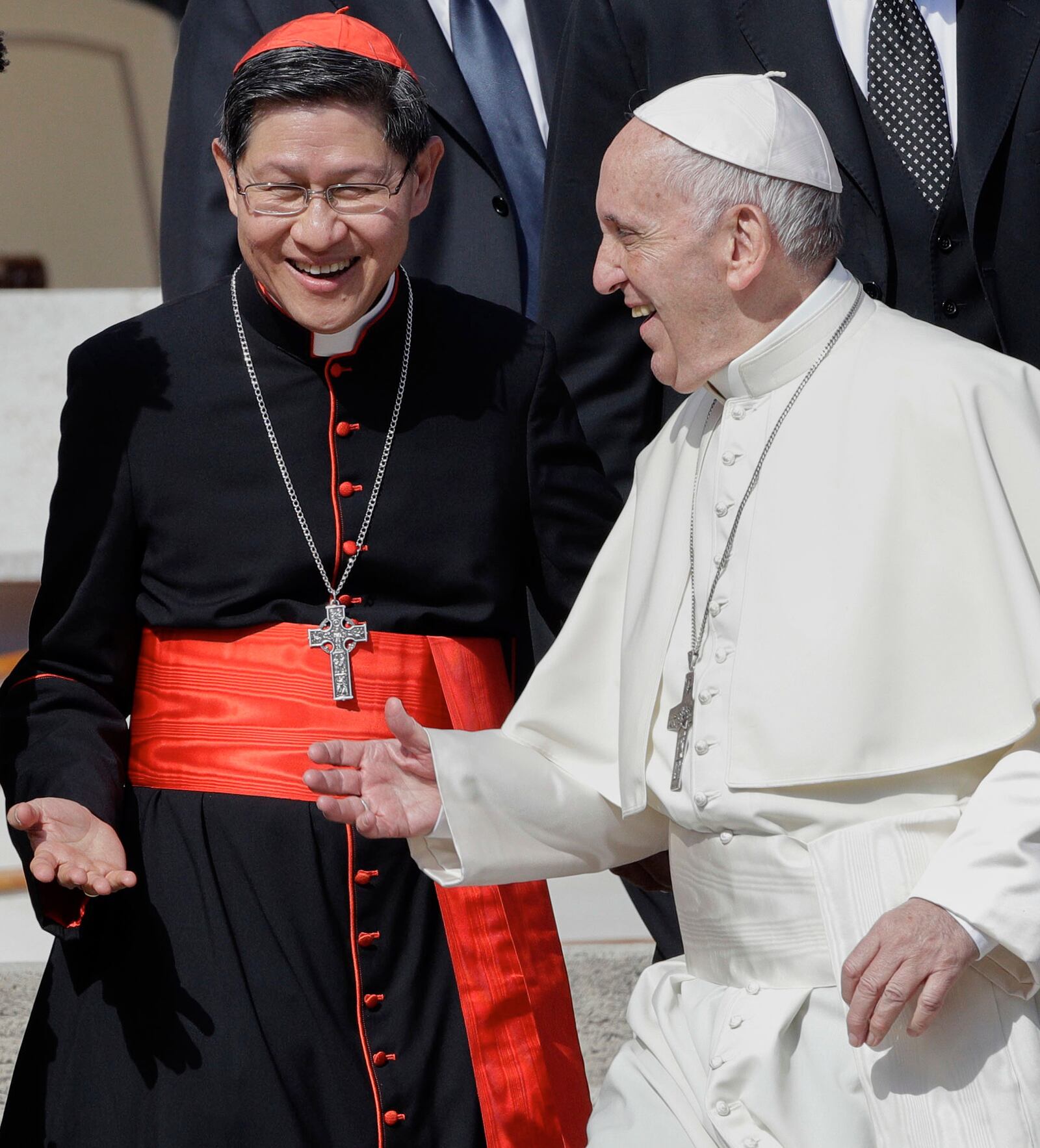 FILE - Pope Francis greets Cardinal Luis Antonio Tagle, archbishop of Manila, second from right, and group of migrants, during his weekly general audience, at the Vatican, Wednesday, Sept. 27, 2017. (AP Photo/Andrew Medichini, File)