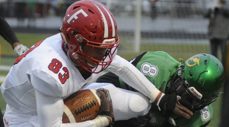 Fairfield’s Erick All (left) is met by Northmont defender Danny Lewis during a game in Clayton on Sept. 1. The host Thunderbolts won 28-21. MARC PENDLETON/STAFF