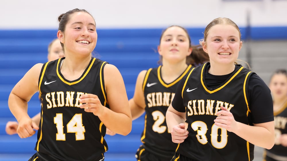 Sidney senior guard Jada Shroyer (left) and freshman guard Norah Kennedy run off the court following a 37-24 win over Greenville in a Division III district quarterfinal on Friday, Feb. 20 at Springfield High School. BRYANT BILLING / STAFF