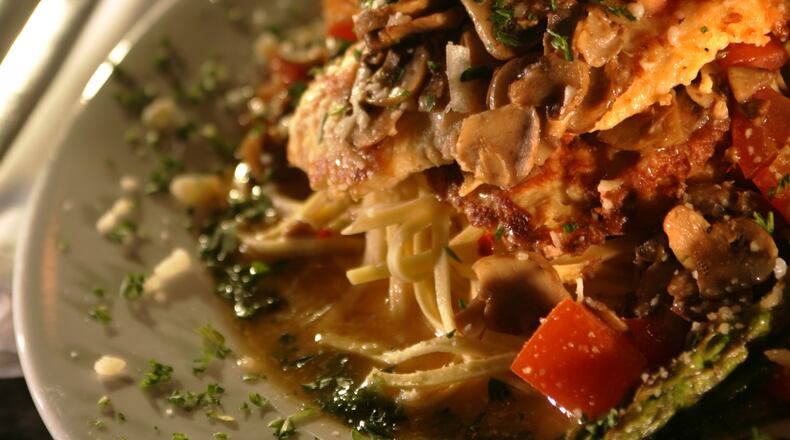Figlio's Restaurant at 424 E. Stroop Road, offers delicious salads. Pictured is a Balsamic Salad with pine nuts and sundried tomatoes, Chicken Piccatta with Linguine and Asparagus, and Creme Brulee with Raspberry Puree. Jim Witmer/Staff