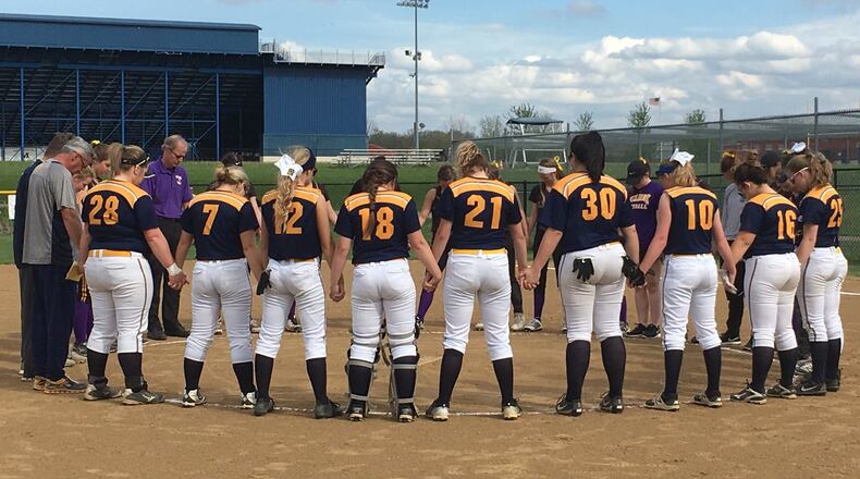 Monroe and Bellbrook players and coaches come together for a pregame prayer at Monroe on Thursday afternoon to honor Monroe senior Kaylie Jackson, who died this week from injuries suffered in a car crash. RICK CASSANO/STAFF
