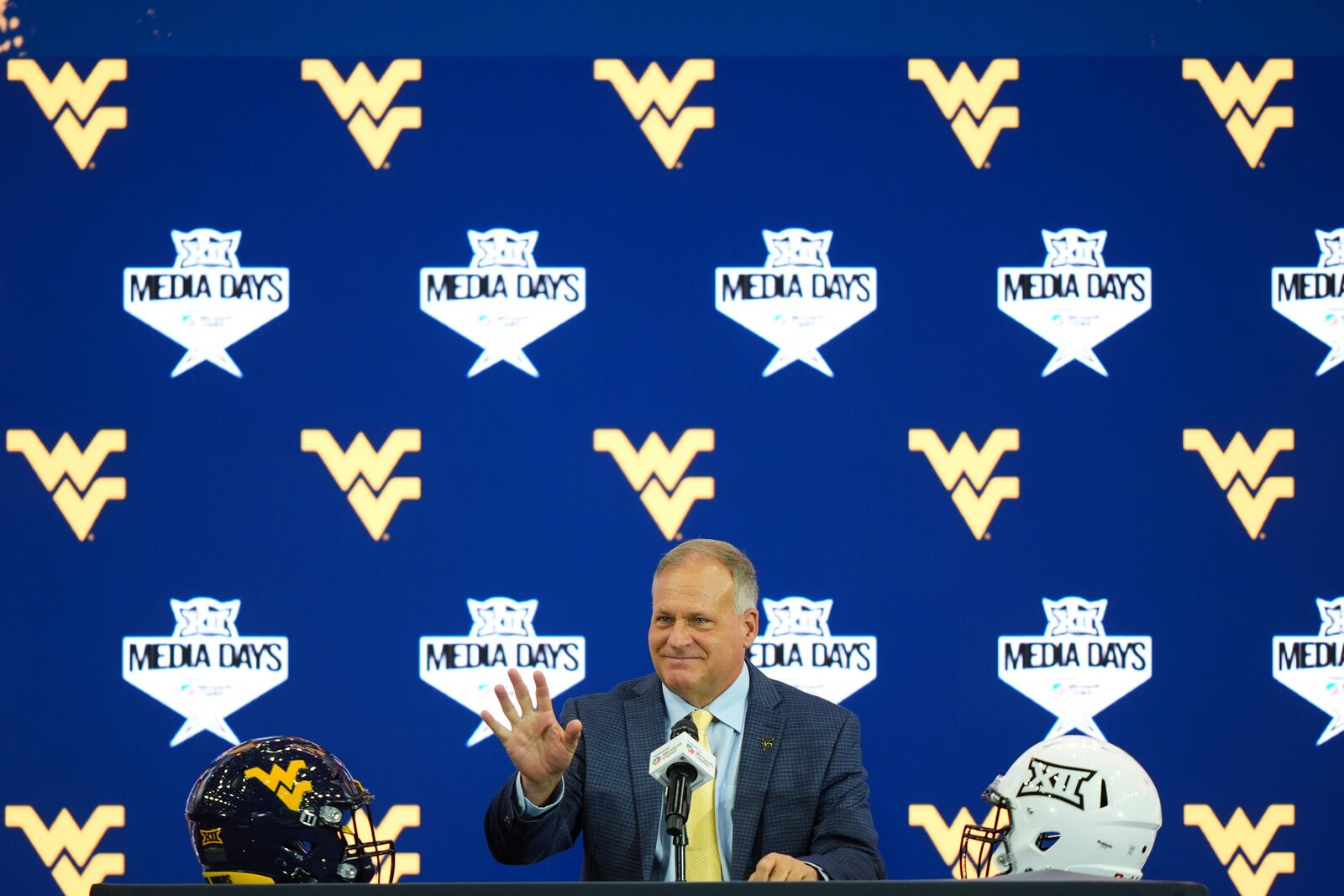 West Virginia head coach Rich Rodriguez waves before speaking during the Big 12 NCAA college football media day in Frisco, Texas, Wednesday, July 9, 2025. (AP Photo/LM Otero)