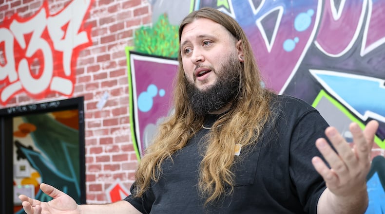 Jesse Burns, co-owner of Bud City Dispo in Fairborn, talks in the store on Tuesday, Oct. 14. The store is continuing to sell its THCa products after Gov. Mike DeWine's 90-day ban on intoxicating hemp-derived THC products, which went into effect on Tuesday. Burns said an attorney who reviewed DeWine's order concluded the ban applies to Delta-8 products specifically. BRYANT BILLING / STAFF