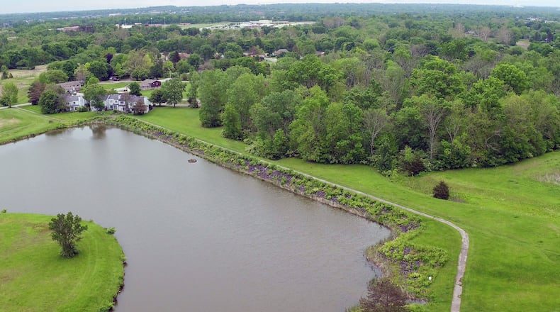 View of Sycamore Woods Lake in Trotwood, looking east, that shows the straight line of an earthen dam that holds the lake in place. The Ohio Department of Natural Resources, Division of Water Resources, is requesting an emergency action plan from the City of Trootwood in the event of a dam breach. TY GREENLEES / STAFF