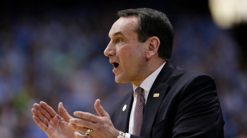 Duke head coach Mike Krzyzewski directs his team during the first half of an NCAA college basketball game against North Carolina in Chapel Hill, N.C., Wednesday, Feb. 17, 2016. (AP Photo/Gerry Broome)