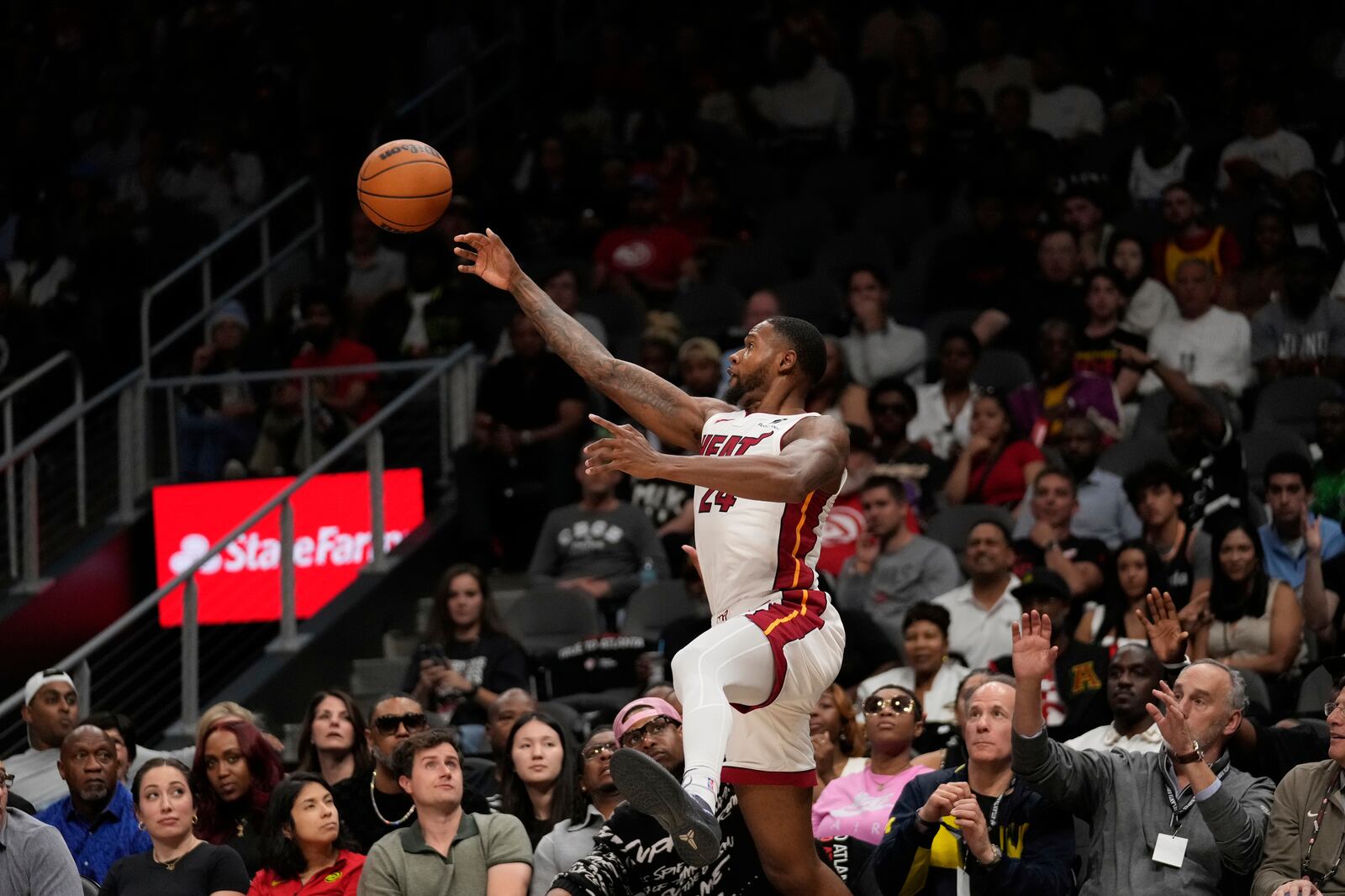 Miami Heat forward Haywood Highsmith (24) keeps the ball in bounds in the first half of an NBA play-in tournament basketball game against the Atlanta Hawks, Friday, April 18, 2025, in Atlanta. (AP Photo/Brynn Anderson)