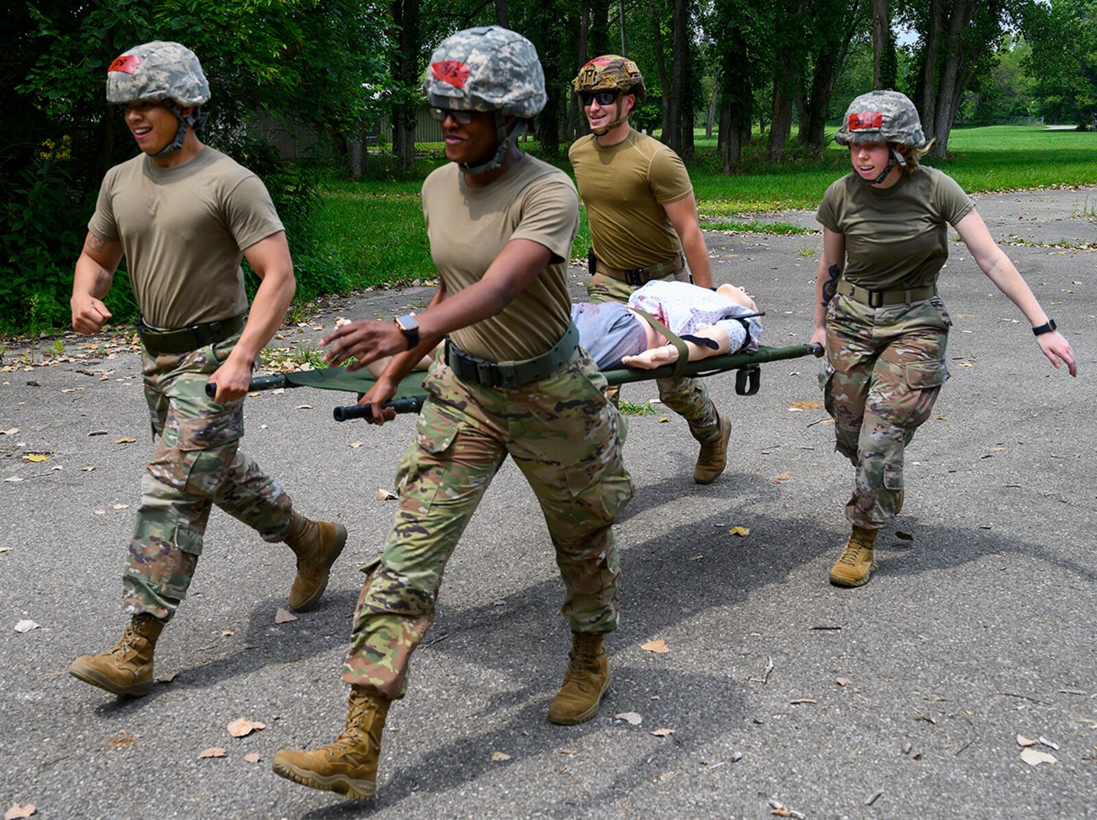 From left: Senior Airman Ivan Tendenilla, 88th Comptroller Squadron; 1st Lt. Juawana Stringer, 88th Medical Group; Airman 1st Class Andrew Ertmer, of the 788th Civil Engineer Squadron’s Explosive Ordnance Disposal Flight; and Senior Airman Kristin Betsch, 88th Medical Group, practice carrying a “patient” on a litter during buddy care training Aug. 11 at the Warfighter Training Center. U.S. AIR FORCE PHOTO/R.J. ORIEZ