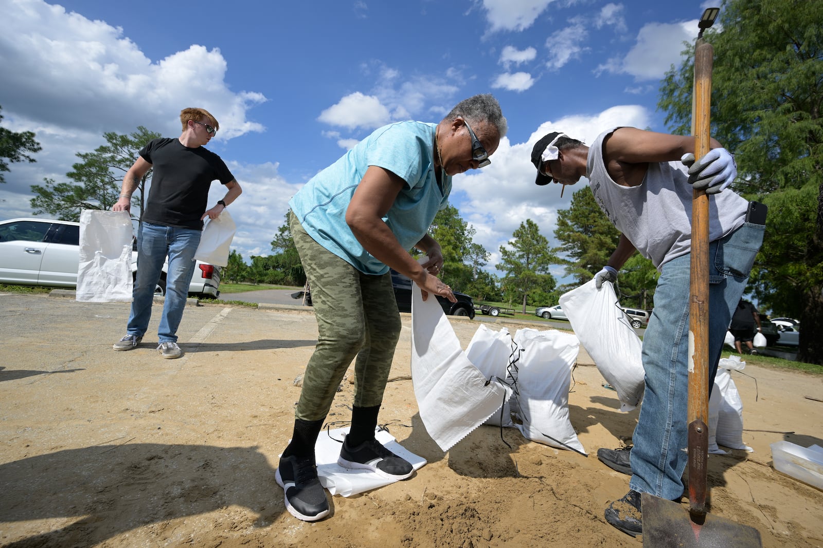 FILE - Johnny Ford, right, and his wife Jerria Ford fill free sand bags at an Orange County park in preparation for the arrival of Hurricane Ian, Monday, Sept. 26, 2022, in Orlando, Fla. (AP Photo/Phelan M. Ebenhack,File)