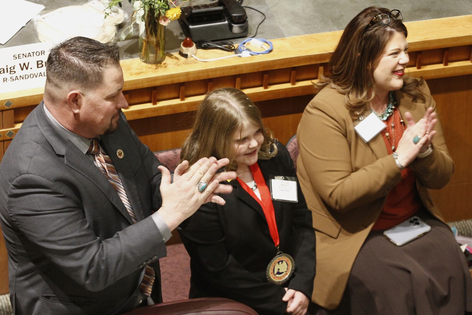 Republican state Sen. Joshua Sanchez of Bosque, N.M., left, applauds a bill to designate tortillas as the official state bread in Santa Fe, on Tuesday, March 18, 2025. (AP Photo/Morgan Lee)