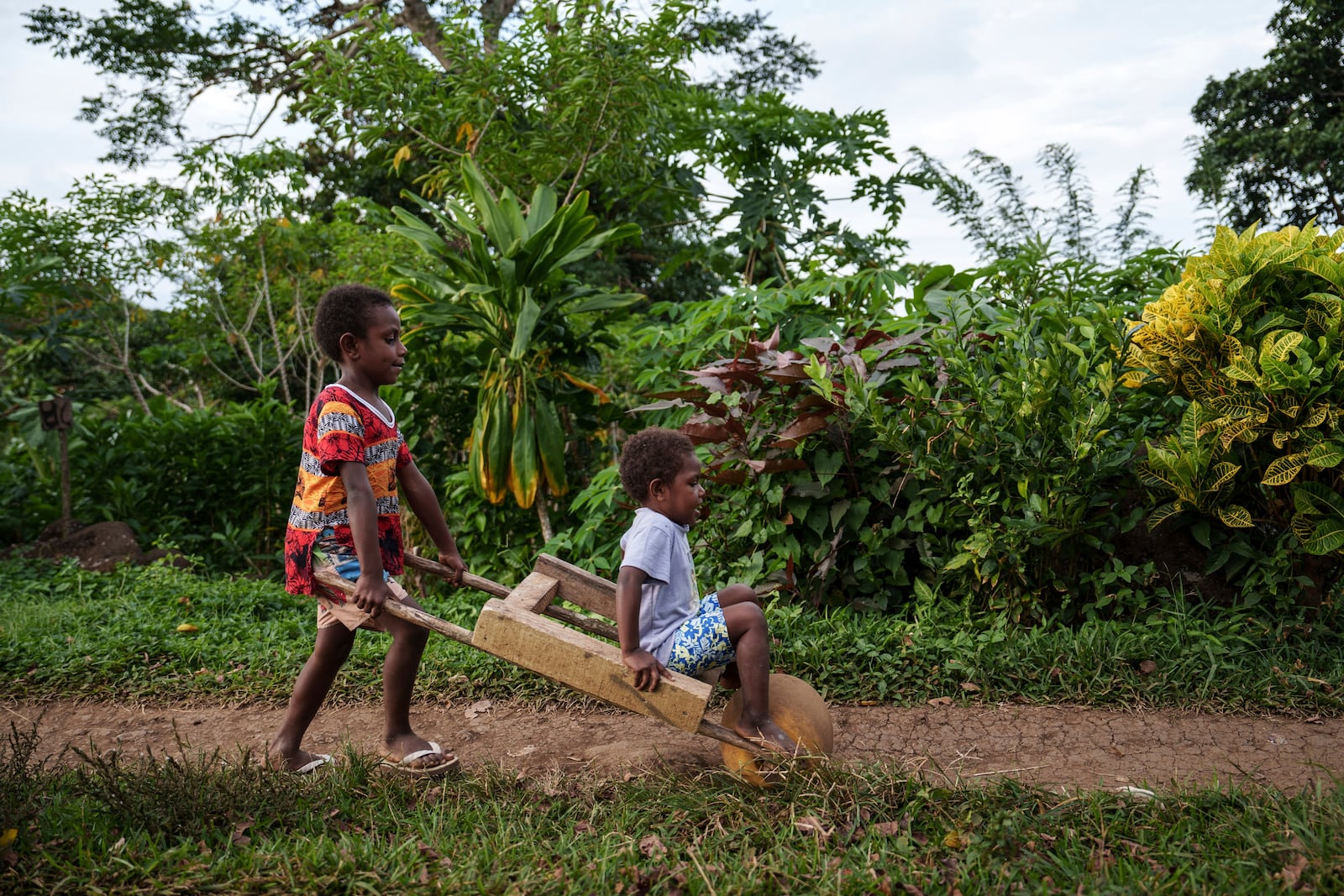 Children play on Pele Island, Vanuatu, Thursday, July 17, 2025. (AP Photo/Annika Hammerschlag)