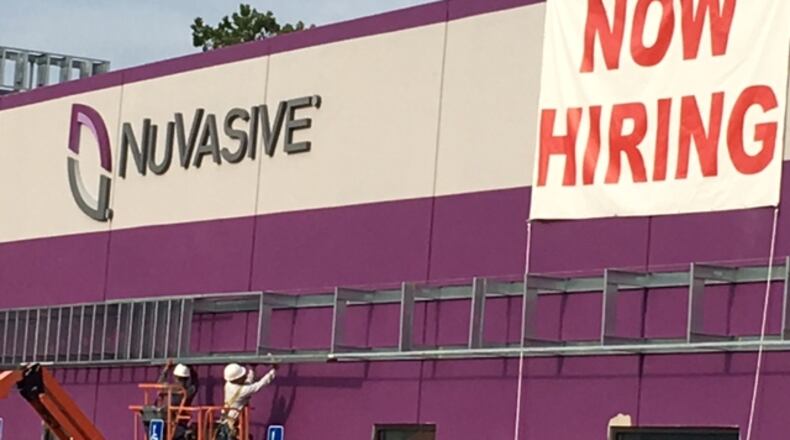 NuVasive Inc., which announced a move from Fairborn to West Carrollton in late 2015 as part of a $45 million expansion, recently had this banner up on its Liberty Lane plant. NICK BLIZZARD/PHOTO
