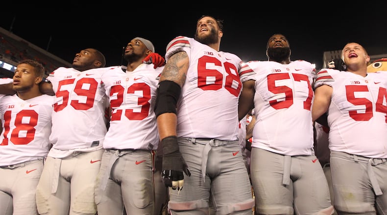 Taylor Decker (68) is shown with other Ohio State players in 2015. Decker is a Vandalia High School graduate. DAVID JABLONSKI/STAFF