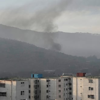 Smoke rises from Fort Tiuna, the main military garrison in Caracas, Venezuela, after multiple explosions were heard and aircraft swept through the area, Saturday, Jan. 3, 2026. (AP Photo/Matias Delacroix)