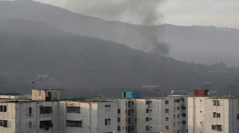 Smoke rises from Fort Tiuna, the main military garrison in Caracas, Venezuela, after multiple explosions were heard and aircraft swept through the area, Saturday, Jan. 3, 2026. (AP Photo/Matias Delacroix)