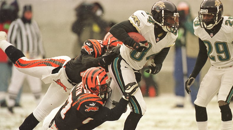 17 Dec 2000: Jacksonville Jaguar Reggie Barlow #84 is tackled Cincinnati Bengals Damon Griffin #87 and Ron Dugans #81 while returning a punt during their game at Paul Brown Stadium in Cincinnati, Ohio. The Bengals won the game 17-14 on a Neil Rackers 27-yard field goal as time expired. Mandatory Credit: Jonathan Daniel/ALLSPORT