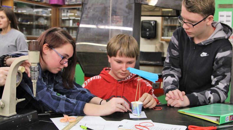 Greenon Junior High School students Riley Hrovatic, Christopher Kahlert and Jordan Gregory work on a project during an 8th-grade STEM class on Friday. HASAN KARIM/ STAFF