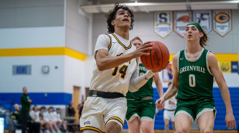Alter High School junior RJ Greer drives past Greenville's Jack Chick (0) during their game on Wednesday night at Springfield High School. The Knights won 80-23. Michael Cooper/CONTRIBUTED