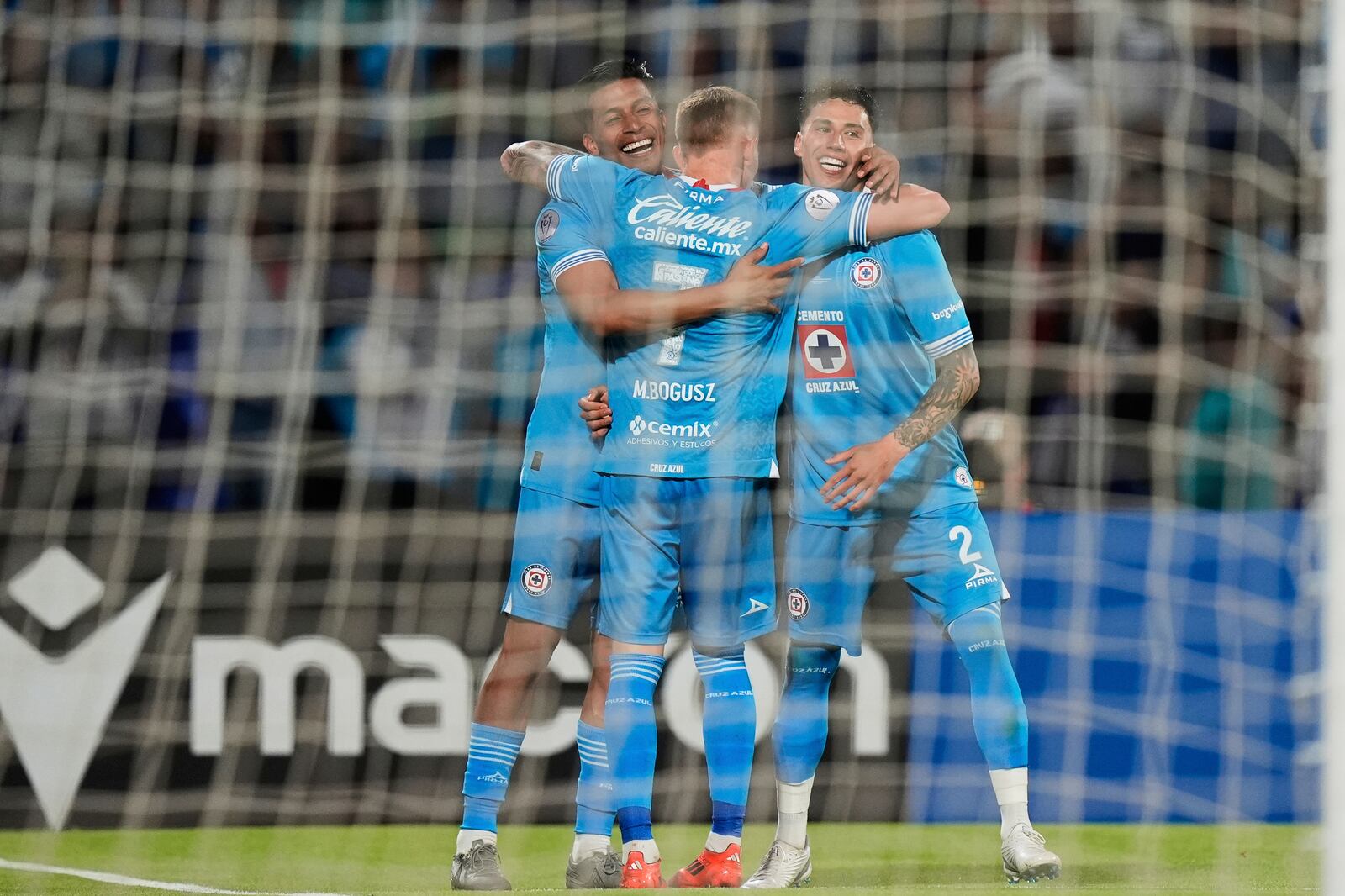 Angel Sepulveda of Mexico's Cruz Azul, left, is congratulated after scoring his side's 5th goal against Canada's Vancouver Whitecaps during the CONCACAF Champions Cup final soccer match in Mexico City, Sunday, June 1, 2025. (AP Photo/Fernando Llano)
