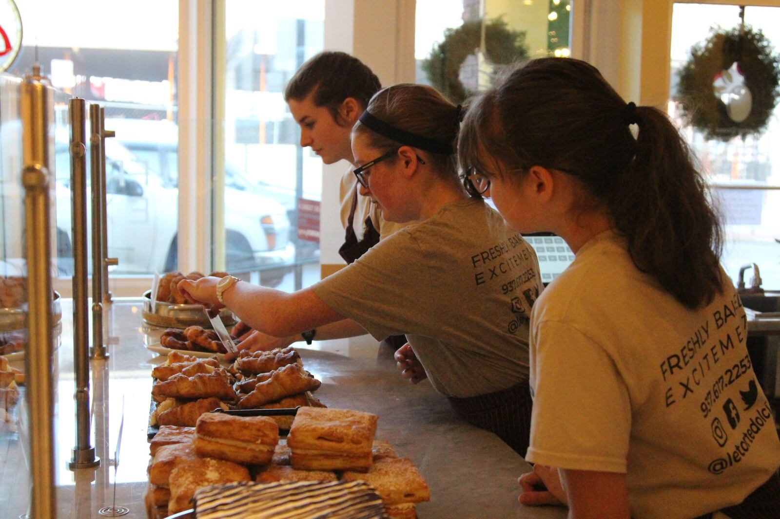 Ella Freeman adjusts a plate of pastries at her parents’ downtown Springfield bakery, Le Torte Dolci. HASAN KARIM/ STAFF
