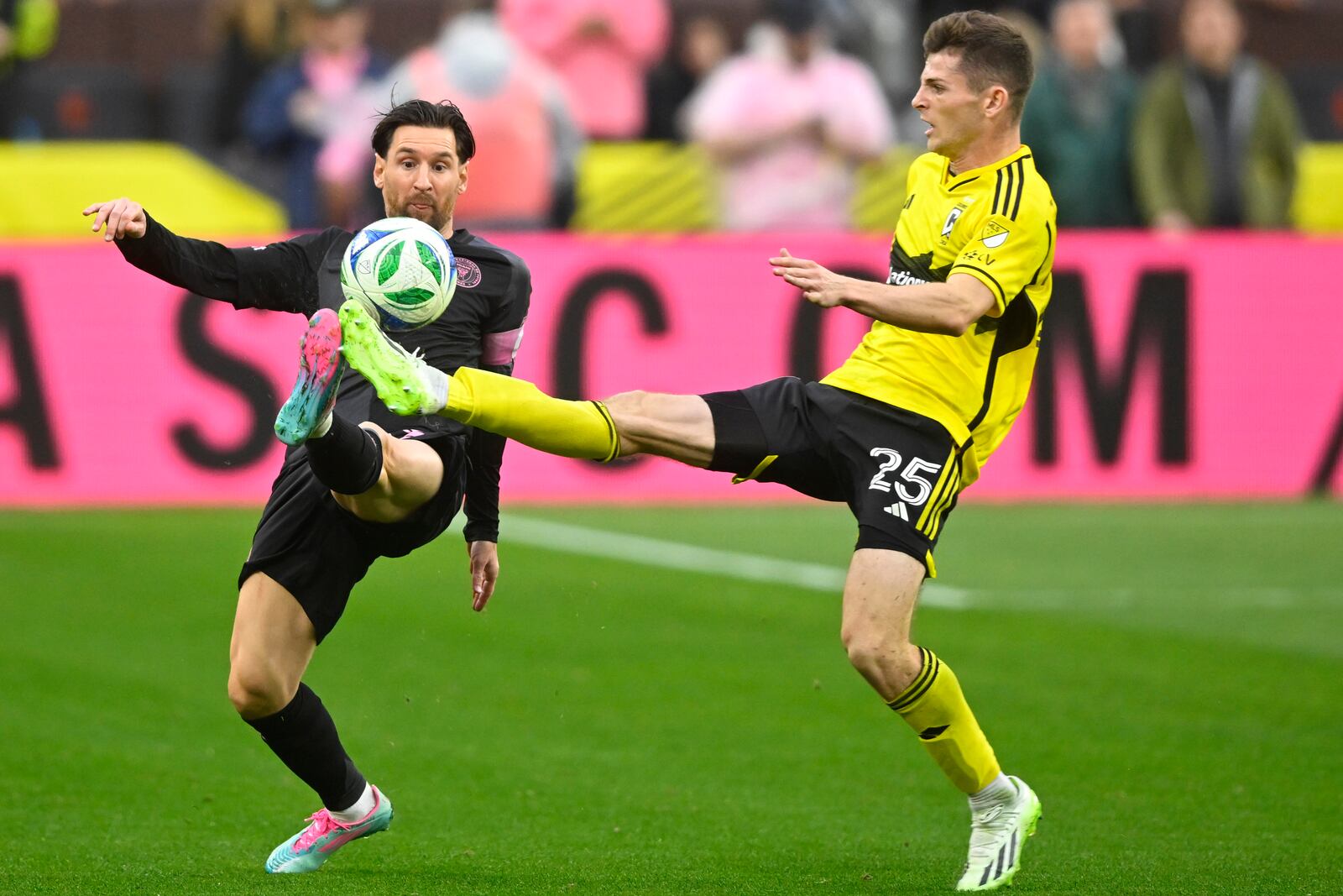 Inter Miami CF forward Lionel Messi, left, and Columbus Crew midfielder Sean Zawadzki kick for the ball during the second half of an MLS soccer match on Saturday, April 19, 2025, in Cleveland, Ohio. (AP Photo/David Richard)