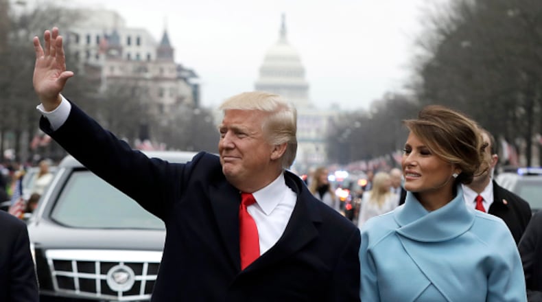 WASHINGTON, DC - JANUARY 20: U.S. President Donald Trump waves to supporters as he walks the parade route with first lady Melania Trump after being sworn in at the 58th Presidential Inauguration January 20, 2017 in Washington, D.C. Donald J. Trump was sworn in today as the 45th president of the United States (Photo by Evan Vucci - Pool/Getty Images)