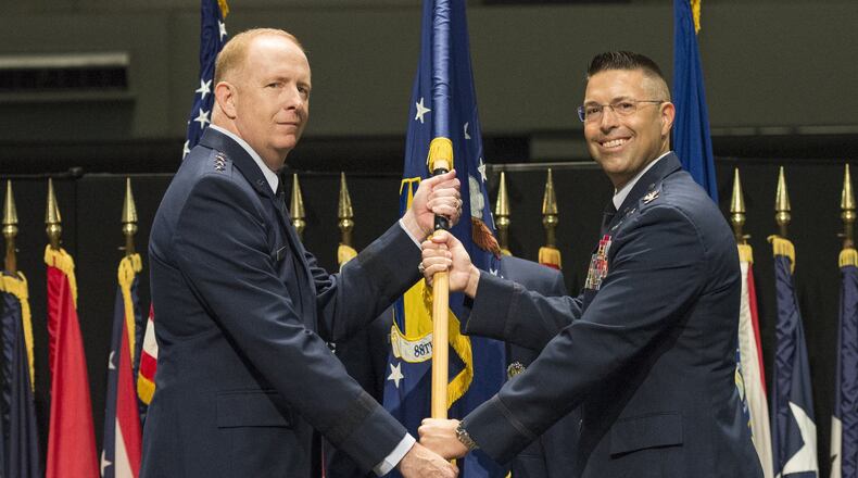 Lt. Gen. Robert McMurry, Air Force Life Cycle Management Center commander, passes the guidon to Col. Thomas Sherman, as he assumes command of the 88th Air Base Wing during a ceremony inside the National Museum of the United States Air Force at Wright-Patterson Air Force Base, June 19. Sherman replaced Col. Bradley McDonald. (U.S. Air Force photo/Wesley Farnsworth)
