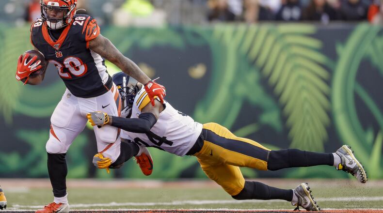 CINCINNATI, OH - NOVEMBER 24: Joe Mixon #28 of the Cincinnati Bengals runs the ball during the second half as Terrell Edmunds #34 of the Pittsburgh Steelers hangs for the tackle at Paul Brown Stadium on November 24, 2019 in Cincinnati, Ohio. (Photo by Michael Hickey/Getty Images)
