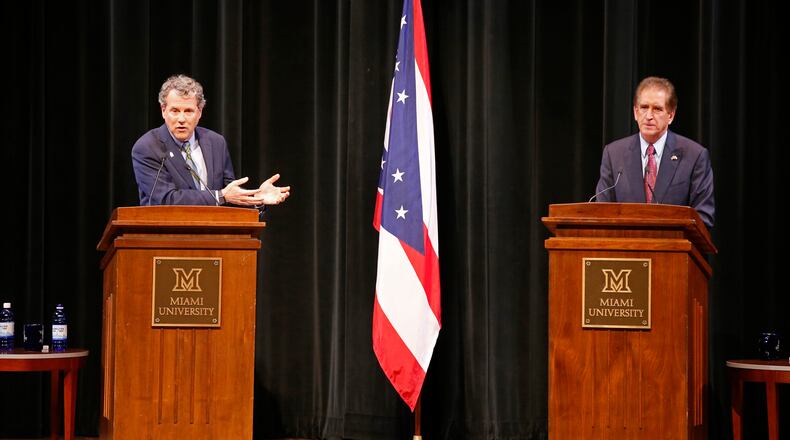 Sen. Sherrod Brown, D-Ohio, left, answers a question as Rep. Jim Renacci, R-Ohio, listens during the U.S. Senate debate at held at Miami University Friday, Oct. 26, 2018, in Oxford, Ohio. (AP Photo/Gary Landers)