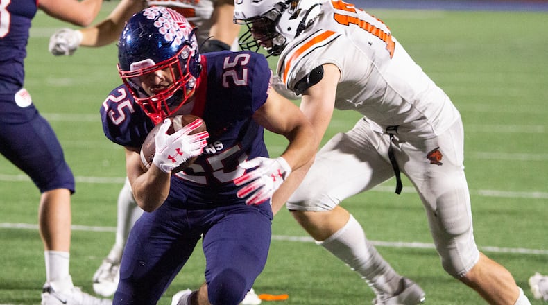 Piqua running back Ca'Ron Coleman bursts through the line for a seven-yard touchdown late in the first half of Friday night's Division II, Region 8 quarterfinal at Alexander Stadium. Jeff Gilbert/CONTRIBUTED