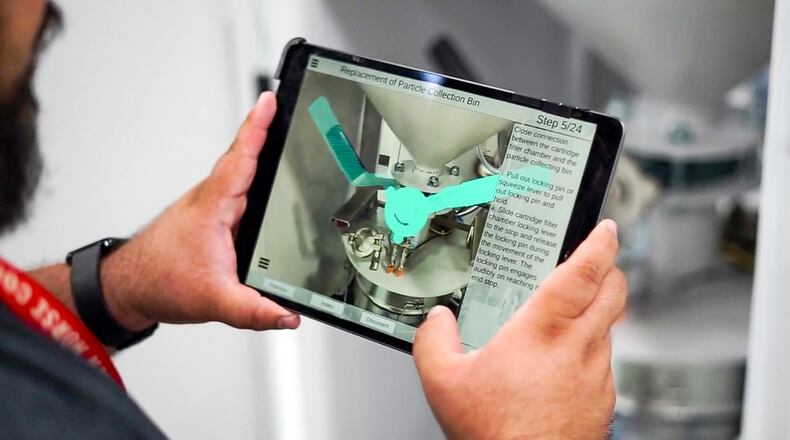 University of Dayton Research Institute computer program Technician Noah Calderon shows how augmented reality can be used to assist in systems maintenance. Contributed