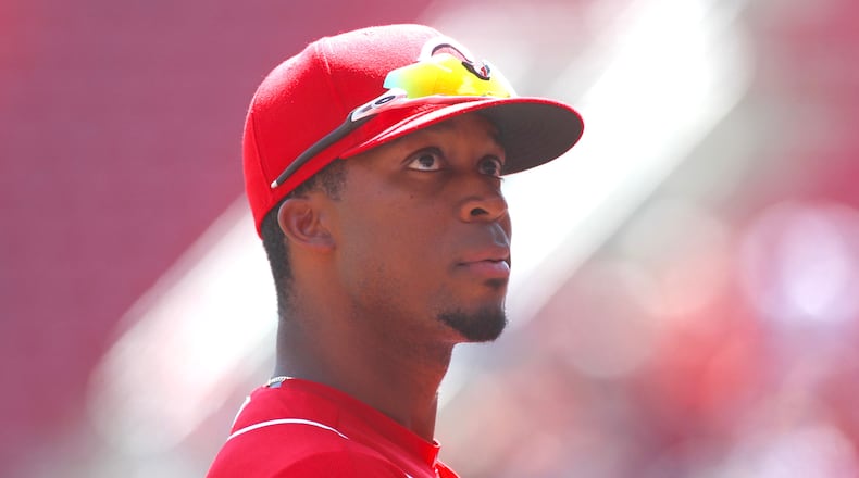 Rosell Herrera watches the action from the Reds dugout during a game against the Braves on Thursday, April 26, 2018, at Great American Ball Park in Cincinnati. David Jablonski/Staff