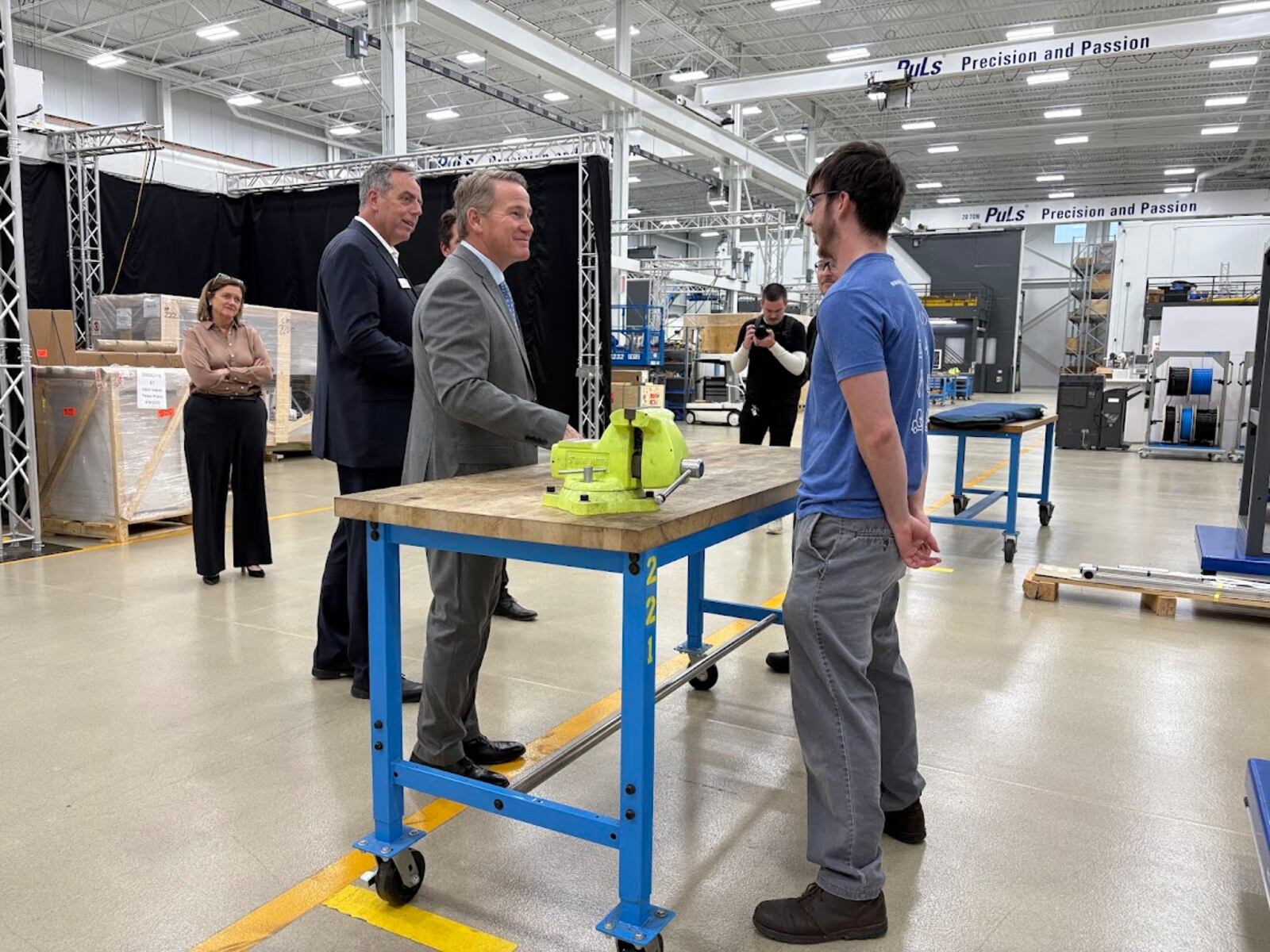Standing at a United Grinding North America work table, Sen. Jon Husted, left, met United Grinding apprentice Trent Saylor on Friday, Dec. 12, 2025. THOMAS GNAU/STAFF