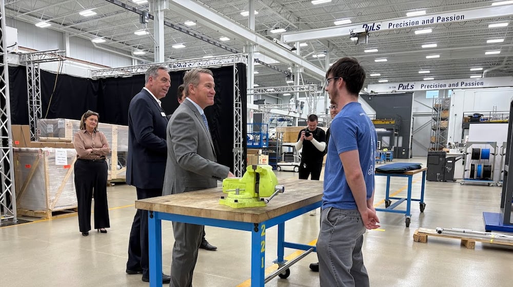 Standing at a United Grinding North America work table, Sen. Jon Husted, left, met United Grinding apprentice Trent Saylor on Friday, Dec. 12, 2025. THOMAS GNAU/STAFF