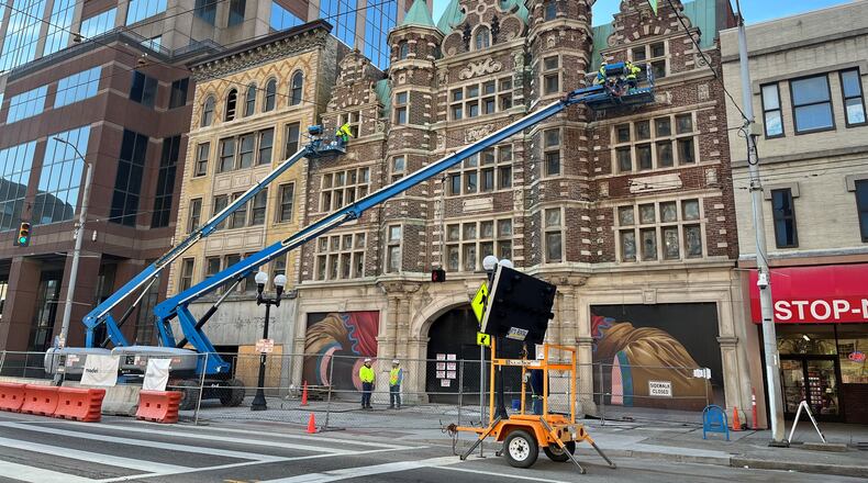 Crews work on the façade of the Dayton Arcade along West Third Street on Wednesday morning, April 12, 2023. Developers plan to turn the two north Arcade buildings into a new hotel and a mix of retail. CORNELIUS FROLIK / STAFF