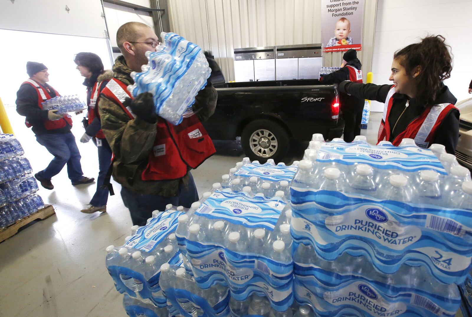 Free water distribution continued at The Foodbank in Dayton on Friday as the City entered its second day of a boil advisory after a water main break on Wednesday. TY GREENLEES / STAFF