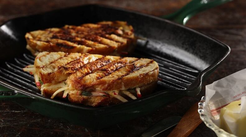 An apple and cheese panino, flavored with mustard and fresh thyme, toasts in a grill pan. (Joan Moravek/food styling) (Abel Uribe/Chicago Tribune/TNS)