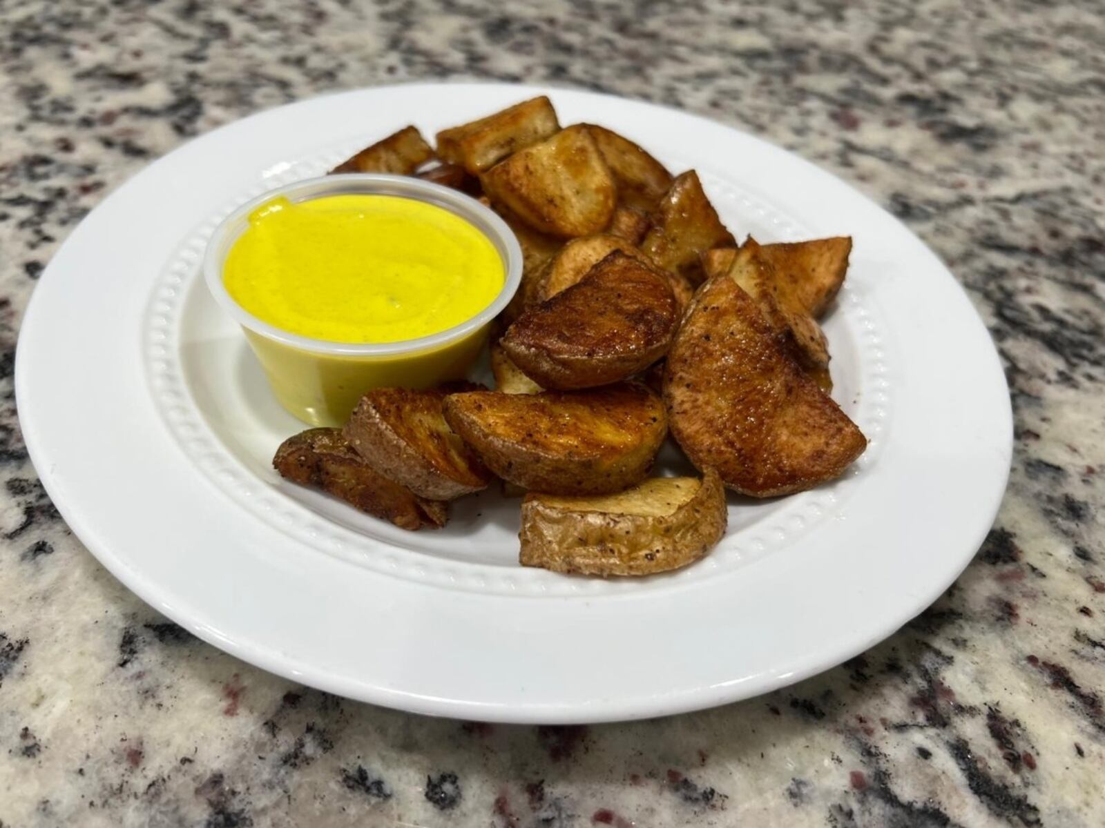 Nando’s Peruvian Crafted Kitchen will host pickup events every other Saturday at Busy Bee Commercial Kitchen, 210 S. Main St. in Springboro. Pictured are the papas doradas con aji, a side of roasted potatoes in a mild, creamy sauce (CONTRIBUTED PHOTO).