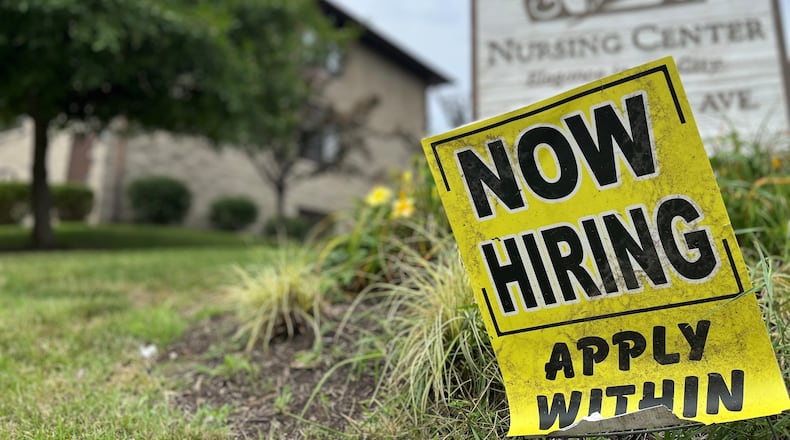 A "now hiring" sign in the Grafton Hills neighborhood in Dayton. CORNELIUS FROLIK / STAFF