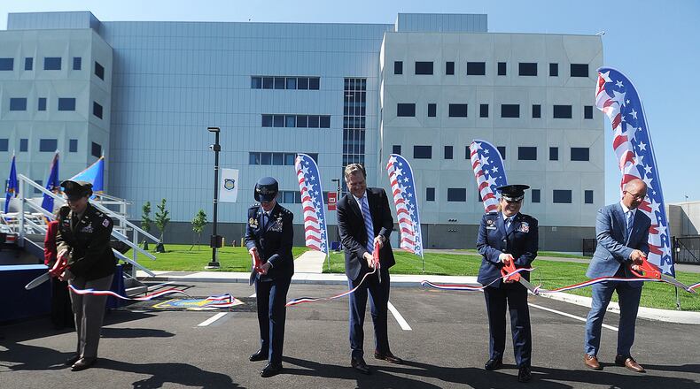 The official ribbon cutting ceremony for the National Air and Space Intelligence Center (NASIC) took place Monday, May 13, 2024. From left, Colonel L. Reyn Mann, Lt. General Leah G. Lauderback, U.S. Congressman Mike Turner, Colonel Ariel G. Batungbacal and Matthew Schnelle, Messer Construction Company. MARSHALL GORBY\STAFF