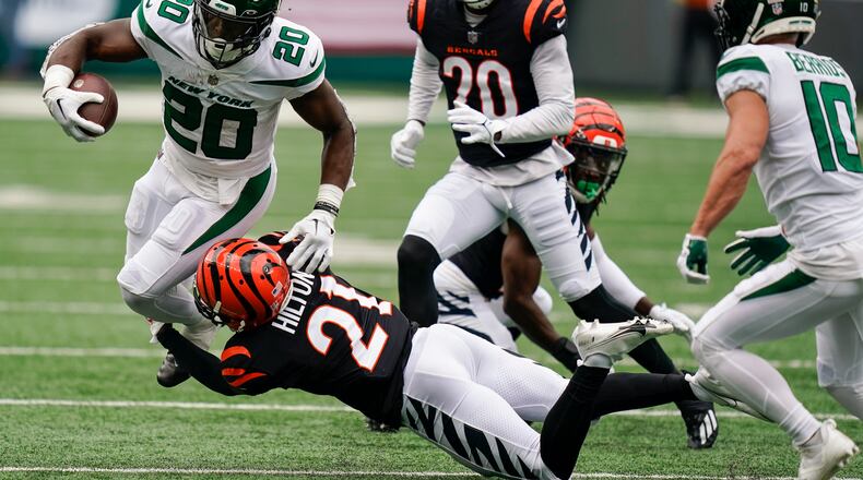 Cincinnati Bengals' Mike Hilton (21) tackles New York Jets' Breece Hall (20) during the first half of an NFL football game Sunday, Sept. 25, 2022, in East Rutherford, N.J. (AP Photo/Seth Wenig)